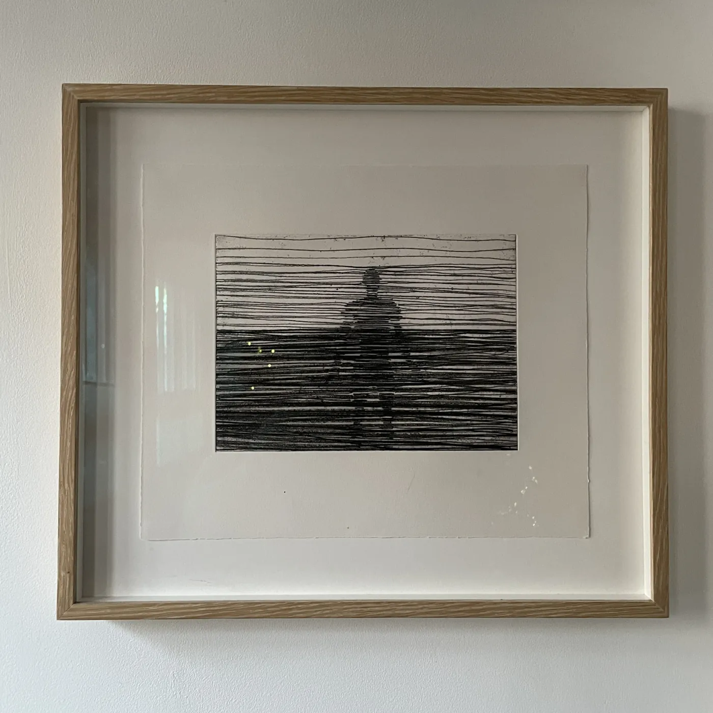 Oak box frame with white mount hanging on a gallery wall